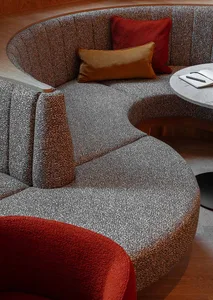 Circular sofa with a textured fabric upholstery, modern design, and comfortable seating.
