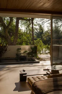A modern interior design contemporary living room with wooden elements, a view of nature, and minimalist furniture.