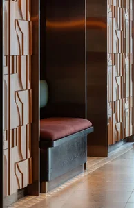 Modern retail shop with wood paneled walls and a bench with a cushion.