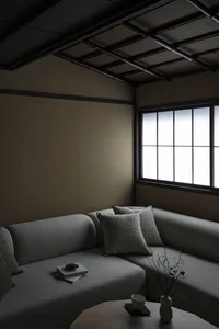 A minimalist living room with grey fabric furniture and wooden accents.