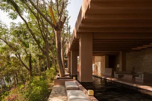 A modern, minimalist residential interior featuring wooden elements and a serene, open design.