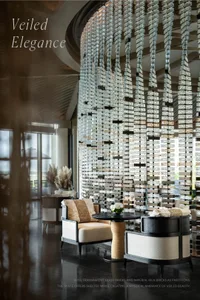 A luxurious hotel lobby featuring modern seating and a decorative glass brick partition