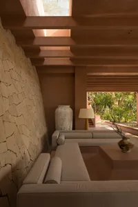 Minimalist living room with concrete furniture and exposed beams