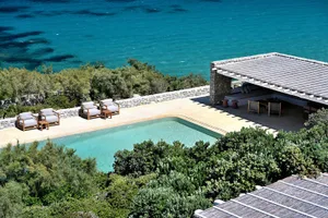 Terracotta roof tiles and lounge area near a poolside.