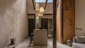 A modern residential interior featuring concrete walls and wooden elements.