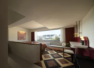 Modern residential space featuring a terrazzo floor and red curtains.