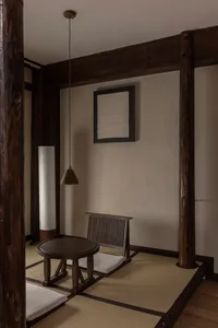 A minimalist living room featuring tatami mats and wooden furniture.