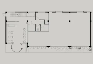 Floor plan of an office space with windows, desks, and a staircase.