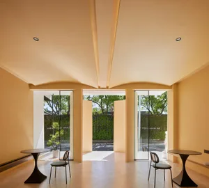 A modern cafeteria with tile flooring and glass walls and doors