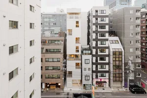 A modern cityscape featuring buildings constructed from concrete, glass, and metal.