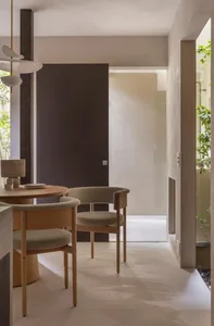 Modern dining room featuring concrete flooring and minimalist chairs.