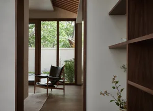 Modern wooden living room showcasing elegant furniture and plants.