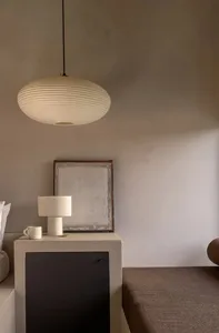 A minimalist bedroom featuring concrete furniture and fabric bedding.