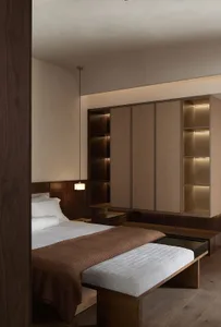 A minimalist bedroom featuring wooden furniture and a cozy atmosphere