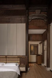 A minimalist bedroom featuring wooden elements