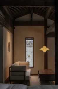 A minimalist living room with wooden furniture and a window view