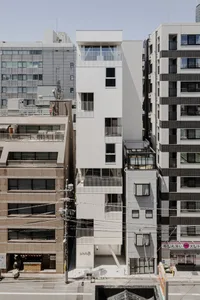 A modern apartment building featuring concrete and glass materials.