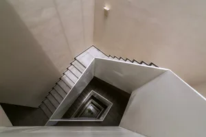 Modern, minimalist concrete staircase photographed from multiple angles.