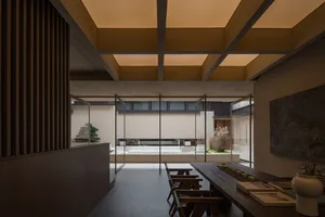 Modern industrial office space with concrete, glass, and metal materials.