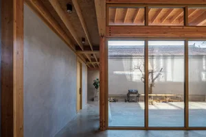 Modern interior design featuring wooden beams and concrete walls