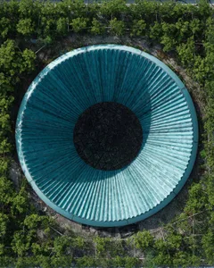 A modern, metallic turbine wheel with radial spokes, viewed from above.