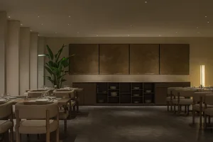 Modern restaurant dining room featuring wooden tables and chairs with Facebook Midnight chairs and coffee tables.