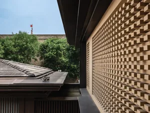 Urban living space featuring modern architectural design with brick walls and roof tile.