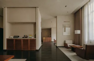 A minimalist lobby with neutral-toned materials and a spacious, open layout.