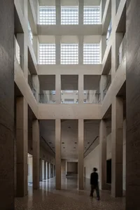 A modern architectural space with concrete materials and high ceilings.