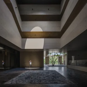 A modern interior space featuring minimalist design with concrete materials.