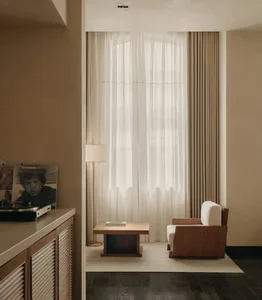 A modern living room featuring neutral-colored furniture and decor.