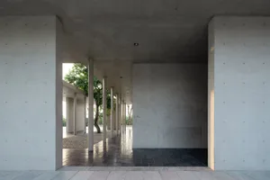 A modern outdoor veranda constructed from concrete, featuring clean lines and a minimalist design.