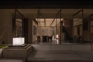 Minimalist modern residential interior with glass walls and open space.