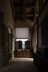 Industrial-style interior with wooden walls, exposed beams, and stone accents.