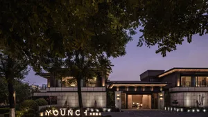 Modern residential exterior featuring concrete, glass, and wood materials.