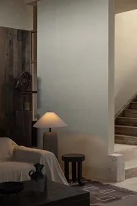 A minimalist living room featuring wooden furniture and decor.