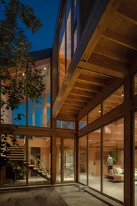 Modern residential interior with wood floors and walls, open design, and natural light.