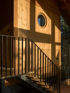 Modern staircase with wooden steps and black metal railings