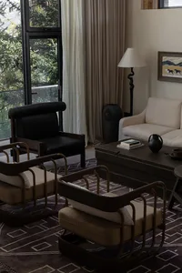 A contemporary living room featuring wooden furniture, a large window, and a comfortable seating area.