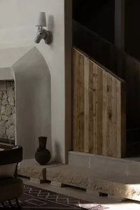 Modern indoor staircase with wooden paneling and stone steps.