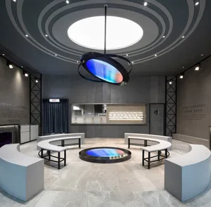 An indoor exhibition hall featuring industrial design elements, including concrete walls, glass displays, and LED lighting.