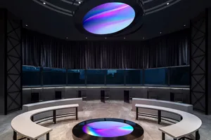 Minimalist design featuring a glass structure in a circular room