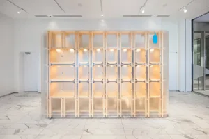 A modern interior featuring a glass storage vestibule with warm lighting.
