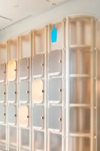 Modern lockers with frosted glass doors in a minimalist design.