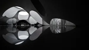 A modern interior space with glass domes reflected in a sleek, shiny floor.