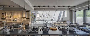 A modern kitchen display featuring various aluminum kitchenware and accessories.