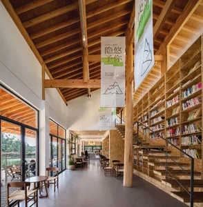 A modern, industrial-style library with an extensive collection of books and a warm, wooden interior.