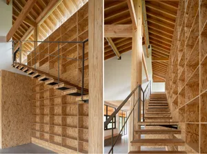Modern interior design featuring wood paneling walls and a staircase.