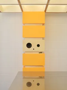 Minimalist furniture pieces with a yellow laminate finish