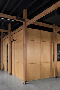 Industrial-inspired interior design featuring wooden panels, showcasing a modern, minimalist aesthetic in a workspace setting
